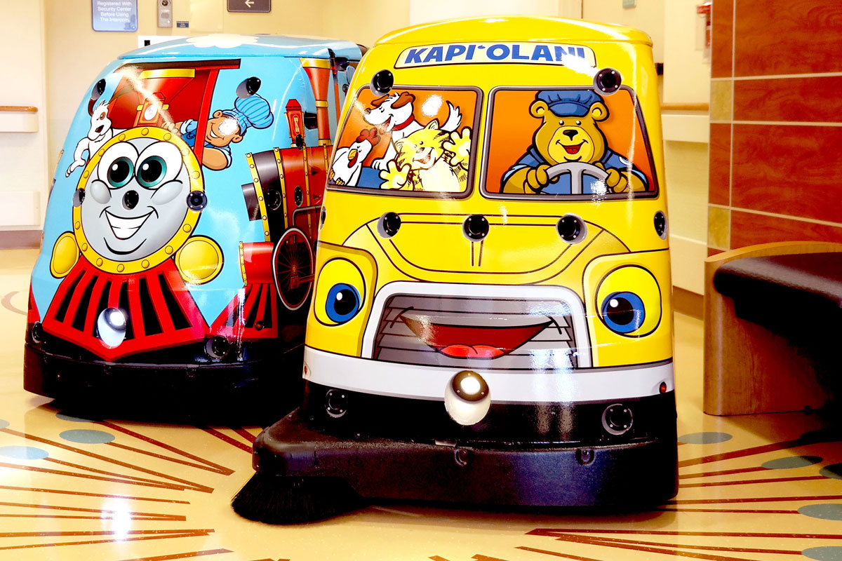 Two clean machines decorated like a train and a bus.
