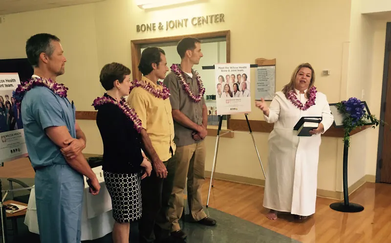 Group of medical professionals and kahu wearing lei at blessing of Wilcox Bone & Joint Center.