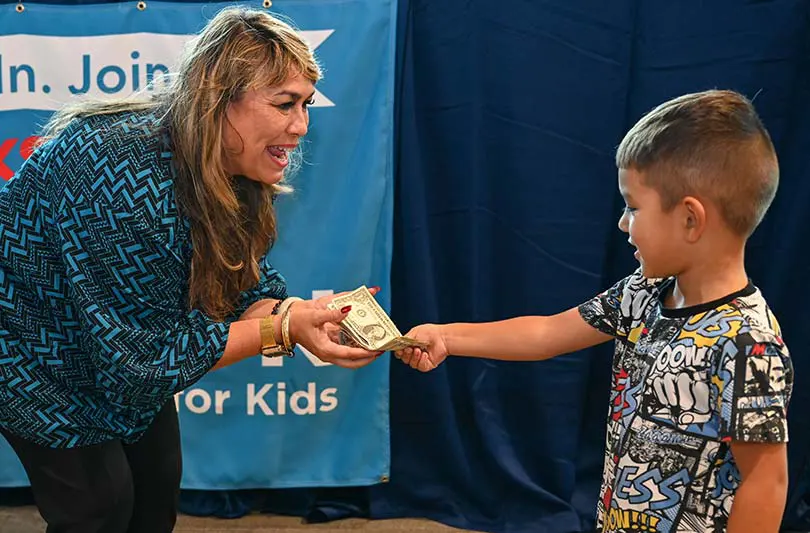 Woman accepting gift from young child