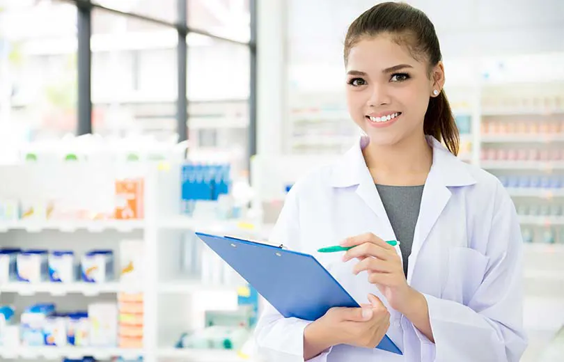 Friendly pharmacist holding a clipboard and pen.